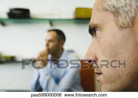 Man, close-up profile, another man in background View Large Photo Image Stock Photograph - Man, close-up profile, another man in background. Fotosearch