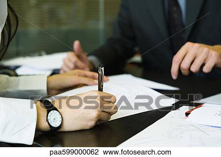 People doing paperwork at desk View Large Photo Image Stock Image - People doing paperwork at desk. Fotosearch