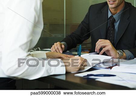 Person signing document in meeting with executive View Large Photo Image Stock Photo - Person signing document in meeting with executive. Fotosearch