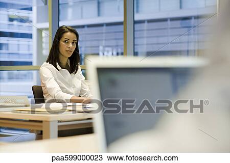 Woman working in office View Large Photo Image Stock Image - Woman working in office. Fotosearch