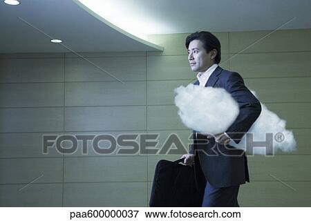 Stock Photo - Businessman walking in corridor. Fotosearch