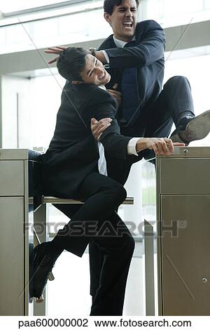 Businessmen fighting to beat each other through turnstile View Large Photo Image Stock Image - Businessmen fighting to beat each other through turnstile. Fotosearch