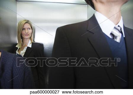 Stock Photo - Businesswoman on elevator. Fotosearch