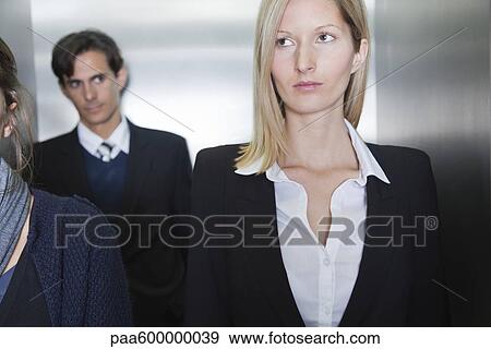 Professionals in elevator View Large Photo Image Stock Photo - Professionals in elevator. Fotosearch