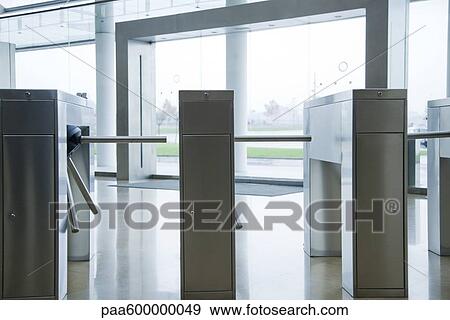 Turnstiles in building lobby View Large Photo Image Stock Photo - Turnstiles in building lobby. Fotosearch