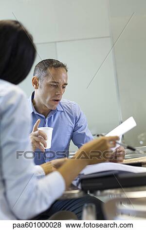 Businessman working with colleague View Large Photo Image Stock Photo - Businessman working with colleague. Fotosearch