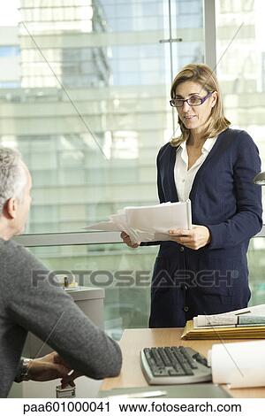 Businesswoman talking to male colleague View Large Photo Image Stock Image - Businesswoman talking to male colleague. Fotosearch