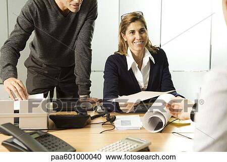 Businesswoman working with colleages in office View Large Photo Image Stock Image - Businesswoman working with colleages in office. Fotosearch