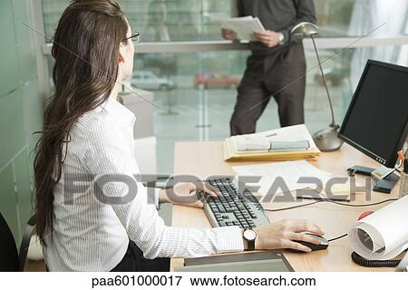 Businesswoman working with colleague View Large Photo Image Stock Photo - Businesswoman working with colleague. Fotosearch
