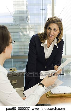 Businesswoman working with colleague View Large Photo Image Stock Photo - Businesswoman working with colleague. Fotosearch