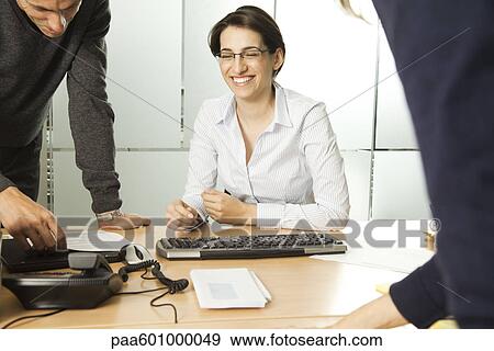 Businesswoman working with colleagues View Large Photo Image Stock Photo - Businesswoman working with colleagues. Fotosearch