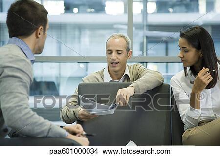 Colleagues discussing work View Large Photo Image Picture - Colleagues discussing work. Fotosearch