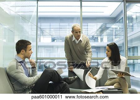 Colleagues discussing work View Large Photo Image Stock Image - Colleagues discussing work. Fotosearch
