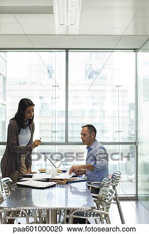 Colleagues discussing work View Large Photo Image Stock Image - Colleagues discussing work. Fotosearch