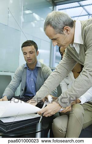 Colleagues discussing work View Large Photo Image Stock Image - Colleagues discussing work. Fotosearch