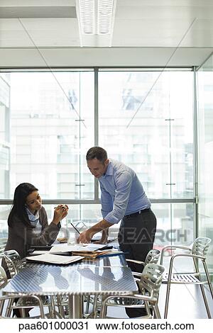 Colleagues discussing work View Large Photo Image Stock Image - Colleagues discussing work. Fotosearch