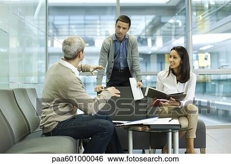 Colleagues discussing work View Large Photo Image Stock Photograph - Colleagues discussing work. Fotosearch