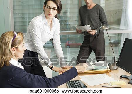 Colleagues discussing work View Large Photo Image Stock Photography - Colleagues discussing work. Fotosearch