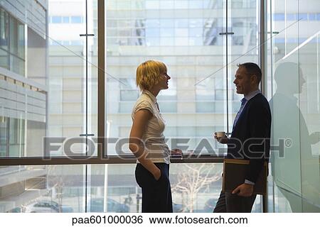 Colleagues in conversation on coffee break View Large Photo Image Stock Photograph - Colleagues in conversation on coffee break. Fotosearch
