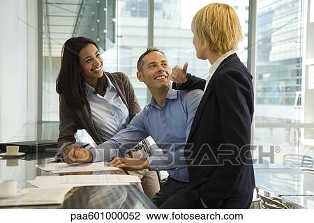 Colleagues talking cheerfully View Large Photo Image Stock Image - Colleagues talking cheerfully. Fotosearch