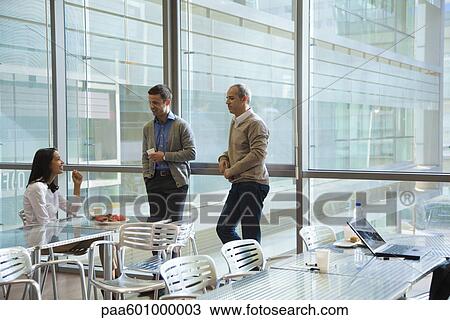 Colleagues talking in office cafeteria View Large Photo Image Stock Image - Colleagues talking in office cafeteria. Fotosearch