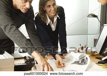 Colleagues working together in office View Large Photo Image Picture - Colleagues working together in office. Fotosearch