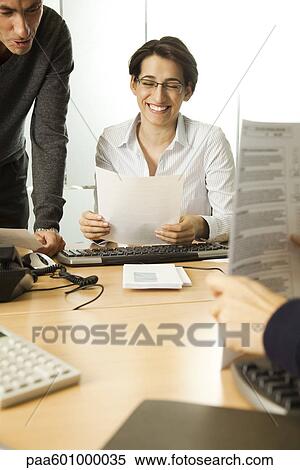 Colleagues working together in office View Large Photo Image Stock Photography - Colleagues working together in office. Fotosearch