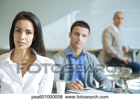Confident woman, men in background View Large Photo Image Stock Photo - Confident woman, men in background. Fotosearch