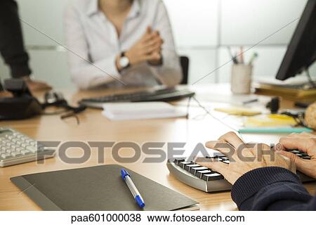 Working in office, cropped View Large Photo Image Stock Photo - Working in office, cropped. Fotosearch