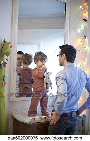 Stock Photograph - Father and son together in nursery. Fotosearch