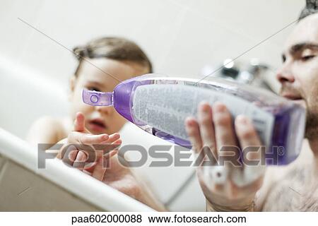 Father and toddler son bathing together View Large Photo Image Stock Photo - Father and toddler son bathing together. Fotosearch