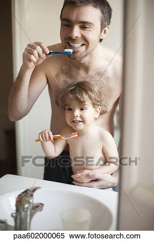 Father and toddler son brushing their teeth together View Large Photo Image Stock Photography - Father and toddler son brushing their teeth together. Fotosearch