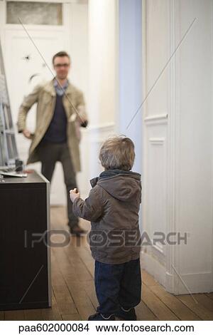 Father and toddler son preparing to leave house View Large Photo Image Picture - Father and toddler son preparing to leave house. Fotosearch