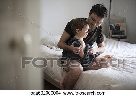 Father drying off toddler son after a bath View Large Photo Image Picture - Father drying off toddler son after a bath. Fotosearch