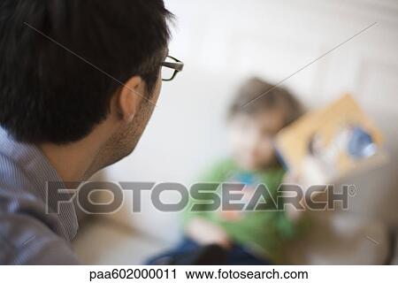Father gazing at young son, over the shoulder view View Large Photo Image Stock Image - Father gazing at young son, over the shoulder view. Fotosearch
