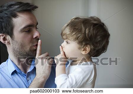 Father teaching toddler son to hush View Large Photo Image Stock Image - Father teaching toddler son to hush. Fotosearch