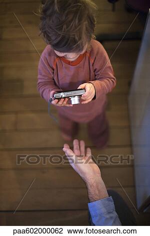 Toddler boy looking at digital camera, overhead view View Large Photo Image Stock Image - Toddler boy looking at digital camera, overhead view. Fotosearch