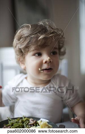Toddler boy with food on his face, portrait View Large Photo Image Stock Photograph - Toddler boy with food on his face, portrait. Fotosearch