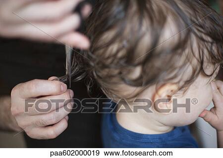 Stock Photo - Toddler getting a haircut, cropped. Fotosearch