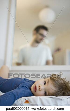 Baby lying on back, reflection of father looking at baby affectionately in mirror View Large Photo Image Stock Photography - Baby lying on back, reflection of father looking at baby affectionately in mirror. Fotosearch