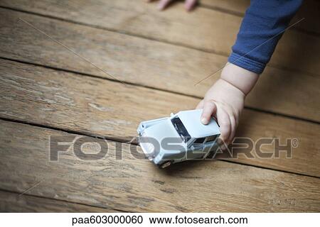 Child's hand holding toy car View Large Photo Image Stock Image - Child's hand holding toy car. Fotosearch