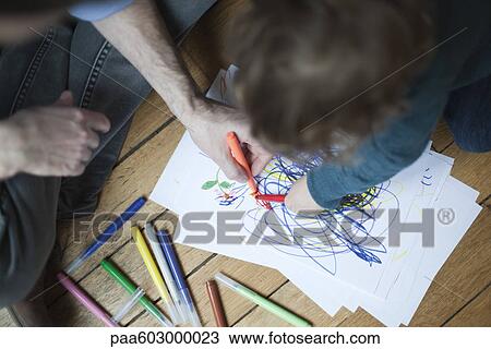 Father and toddler drawing together on paper, high angle view View Large Photo Image Stock Image - Father and toddler drawing together on paper, high angle view. Fotosearch
