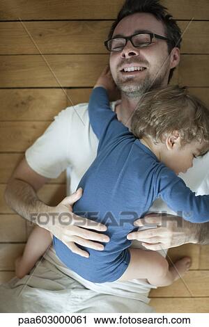 Father and toddler son embracing, portrait View Large Photo Image Stock Image - Father and toddler son embracing, portrait. Fotosearch