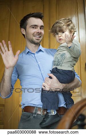 Father and toddler son waving at camera View Large Photo Image Stock Photo - Father and toddler son waving at camera. Fotosearch