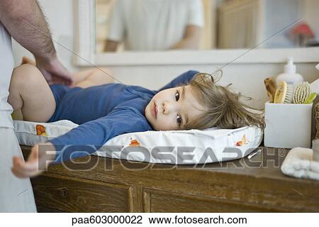 Father changing baby's diaper View Large Photo Image Stock Image - Father changing baby's diaper. Fotosearch