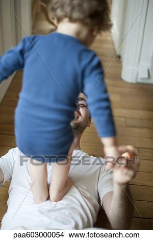 Picture - Father playing with toddler son. Fotosearch