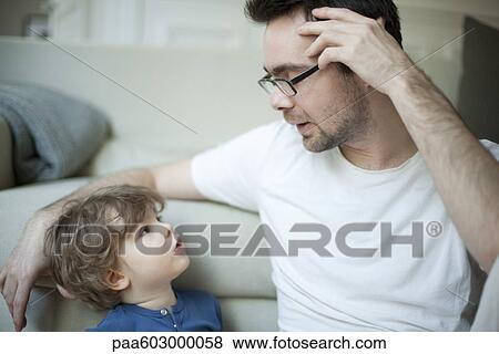 Father talking to young son, portrait View Large Photo Image Stock Photo - Father talking to young son, portrait. Fotosearch