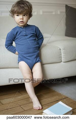 Little boy leaning against sofa, portrait View Large Photo Image Stock Photo - Little boy leaning against sofa, portrait. Fotosearch