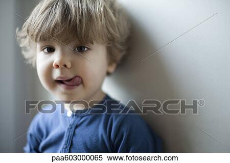 Little boy sticking out tongue, portrait View Large Photo Image Stock Photography - Little boy sticking out tongue, portrait. Fotosearch
