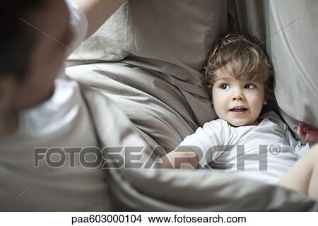 Toddler boy and father in bed View Large Photo Image Picture - Toddler boy and father in bed. Fotosearch